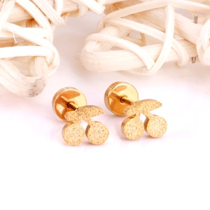 Detailed view of gold stainless steel cherry earrings with sparkling glitter finish texture