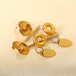 Three gold stainless steel earrings featuring spiral texture and irregular geometric shapes