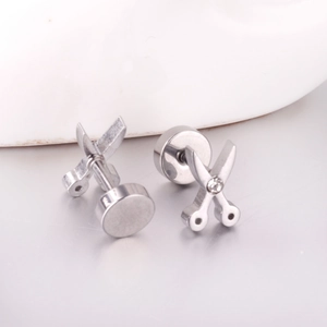 Detail of silver scissors stud earrings with a small diamond accent and secure screw back
