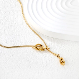 Elegant gold-tone stainless steel snake chain necklace featuring a unique knot pendant design