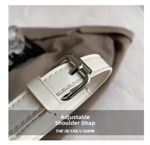 Close-up of adjustable white leather shoulder strap with silver buckle on box bag