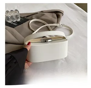 Close-up of the wear-resistant base and smooth white matte leather of the shoulder bag