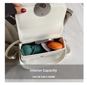 Close-up of a white box bag showing its internal capacity for an umbrella and phone
