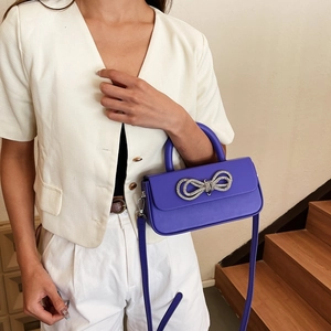 Fashionable purple bow crossbody bag with silver crystal buckle and top handle