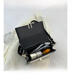 Internal view of bicolor crossbody bag showing dual compartments and daily essentials