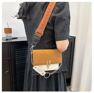 Detail view of retro tricolor flap bag featuring wide heart strap and gold chain
