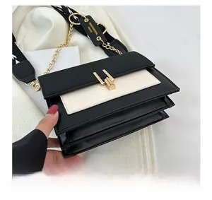 Detailed bottom view of the black and white crossbody bag showing multi-layer accordion folds