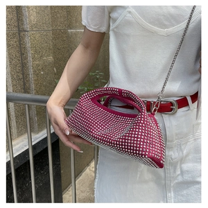 Detail of fuchsia rhinestone evening bag with silver studs and metal chain strap