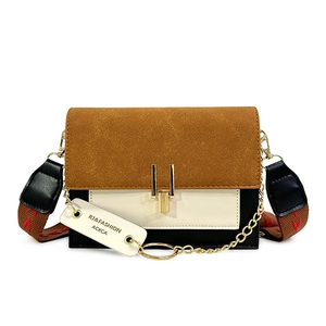 Retro color-block crossbody bag with wide patterned strap and gold hardware on white background