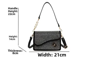 Detail view of sparkly rhinestone shoulder bag with bear ornament and size dimensions