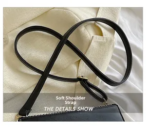 Detail of the soft shoulder strap and premium metal zipper on the black leather square bag