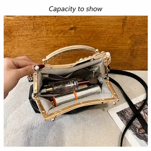 Interior view of vintage black shell bag showing capacity with pearl and gold clasp