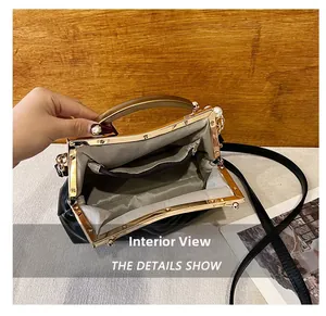 Detail of vintage shell bag interior with herringbone lining and pearl clasp