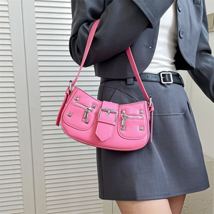 Pink vintage hobo bag with silver rivets and metal buckle shown on model