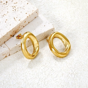 Minimalist 18k gold-plated irregular oval hoop earrings on a textured stone surface
