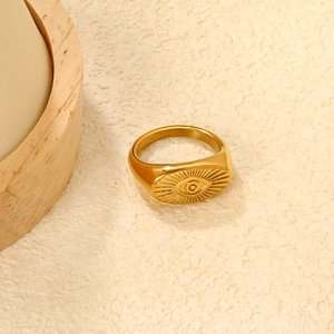 Macro view of 18K gold plated stainless steel ring with radiant evil eye engraving
