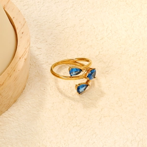Adjustable gold ring featuring three claw-set blue pear-shaped cubic zirconia stones