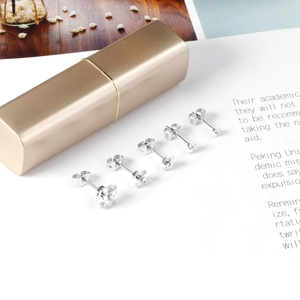 Five-piece set of four-claw round zirconia stud earrings in varying sizes on magazine