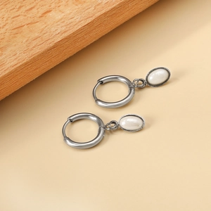 Elegant silver stainless steel oval faux pearl earrings set against a minimalist background