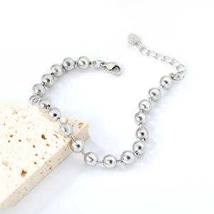 Detailed macro view of silver beaded steel bracelet with lobster clasp and extender