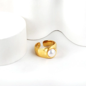 Close-up of golden matte silk texture ring with a round white pearl inlay
