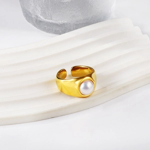 Detail of 18K gold stainless steel wide band ring with a large white pearl center