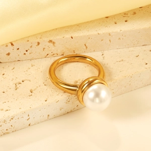 Macro detail of an 18K gold plated stainless steel ring with a large white round pearl
