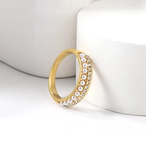 Macro detail of 18K gold plated ring featuring white pearls and sparkling crystal accents