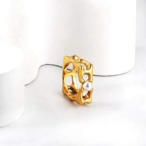 Detail of 18K gold stainless steel ring with white pearl and geometric cutout design