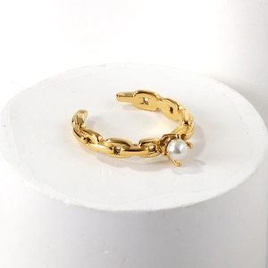 Detailed macro of 18K gold plated Cuban chain ring with a single white pearl detail