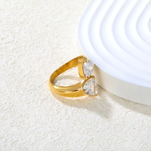 Close-up of 18K gold plated ring featuring two sparkling heart-shaped cubic zirconia
