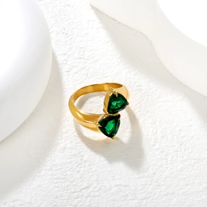 Triangle emerald stones set in 18K gold plated open ring on elegant white art background