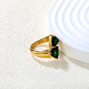 Close-up of triangle emerald stones on a minimalist 18K gold plated open ring