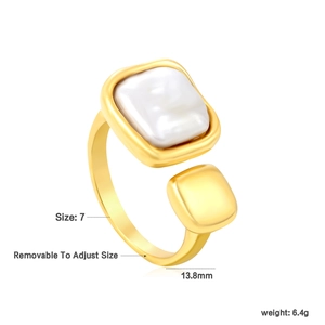 Detail of adjustable gold ring featuring a square pearl inlay and open geometric design