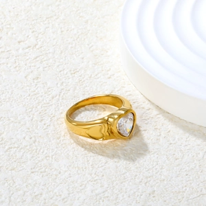Macro detail of 18K gold plated ring featuring heart-shaped zircon and side heart relief
