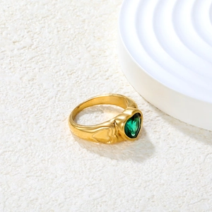 Detail of 18K gold plated heart ring with green zircon and side engraving