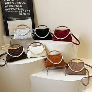 Chic wave-pattern shell bags with pearl handles and cross-body straps in seven colors