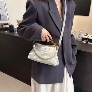 Elegant marble pattern shell bag with pearl handle and metal frame closure