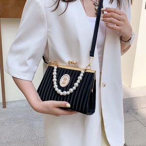 Elegant black pleated evening bag with large pearl handle and vintage oval crest badge