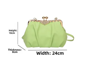 Detail shot of mint green pleated shell bag showing dimensions 24x18x8cm and rhinestone clasp