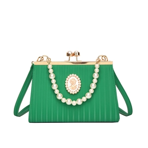 Elegant emerald green evening clutch with pearl handle and queen cameo badge decoration