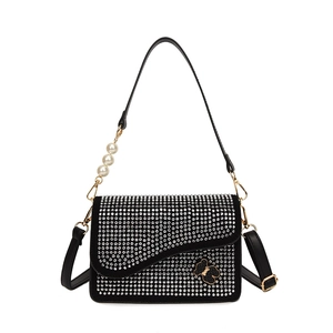 Black glitter crossbody bag with rhinestones, metal bear detail, and pearl handle strap