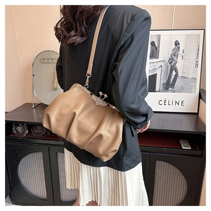 Detail of khaki cloud bag with crystal metal clasp and soft leather pleats