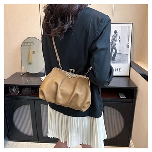 Detailed close-up of the vintage kiss-lock closure with crystal floral accents on khaki bag