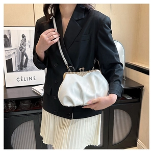 Détail du sac nuage blanc plissé avec fermoir doré vintage porté en bandoulière