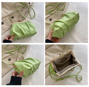 Detail view of light green shell bag showing metal frame closure and internal pockets