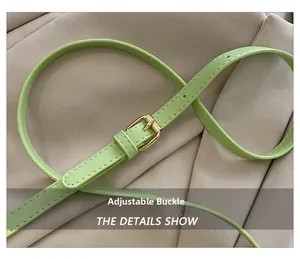 Detail of adjustable mint green leather strap with elegant gold buckle and fine stitching