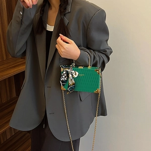Green pleated box handbag with gold handle, silk scarf detail and chain shoulder strap