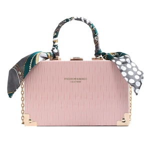 Pink retro box handbag with scarf handle and gold chain strap on white background