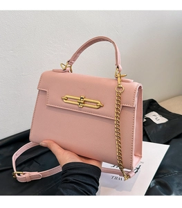 Detalle del bolso rosa en cuero Saffiano con cierre de metal dorado y cadena fina